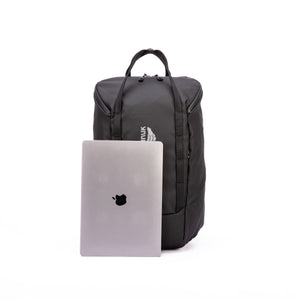 Black backpack with a laptop on a white background