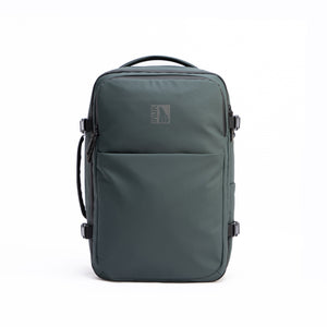 INUK NAVI 38L travel backpack in Black Forest Green, front view with zippered pocket