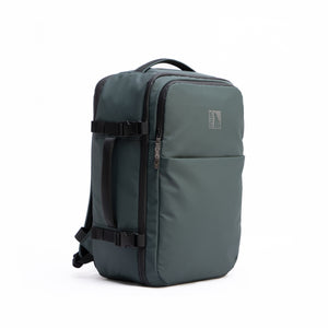 INUK NAVI Black Forest Green 38L backpack, angled side view showing the travel pack shape